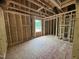 Unfinished room showing plumbing, electrical framework, and window view under construction at 5504 Jaeger Dr # 76, Graham, NC 27253