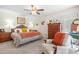 Cozy bedroom with neutral colors and a sitting area with a comfortable chair at 608 20Th St, Butner, NC 27509