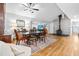 Dining room with hardwood floors, brick fireplace, and a ceiling fan at 608 20Th St, Butner, NC 27509