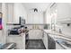 Stylish kitchen featuring white cabinets, modern appliances, and sleek countertops at 608 20Th St, Butner, NC 27509