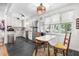 Bright kitchen with white cabinetry, stainless steel refrigerator, and cozy breakfast nook area at 608 20Th St, Butner, NC 27509