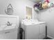Functional laundry room with sink, storage shelves, and modern washer and dryer at 608 20Th St, Butner, NC 27509