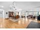 Open-concept living room with hardwood floors connecting to a dining area and seating area at 608 20Th St, Butner, NC 27509
