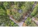 Secluded home nestled in a lush green forest setting with mature trees and winding roads at 6321 Malvern Ln, Hillsborough, NC 27278