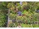 Aerial view of a home surrounded by mature trees, offering privacy and a natural setting at 6321 Malvern Ln, Hillsborough, NC 27278