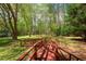 Backyard view featuring a wooden bridge that crosses a garden and lawn area at 6321 Malvern Ln, Hillsborough, NC 27278