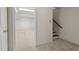 Basement entrance featuring carpeted stairs leading to a spacious, bright room ready to be personalized at 6321 Malvern Ln, Hillsborough, NC 27278
