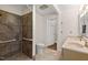 Bathroom featuring tiled shower with grab bars, double sink vanity, and neutral finishes at 6321 Malvern Ln, Hillsborough, NC 27278