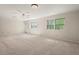 Bright bedroom with neutral carpet, two large windows with views, and a ceiling fan at 6321 Malvern Ln, Hillsborough, NC 27278