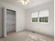 Small bedroom with carpet, closet, and two windows providing natural light and views at 6321 Malvern Ln, Hillsborough, NC 27278