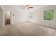 Spacious bedroom with neutral carpet, two windows for natural light, and ceiling fan at 6321 Malvern Ln, Hillsborough, NC 27278