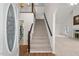 Bright entryway showcasing a staircase, chandelier, hardwood and carpet flooring at 6321 Malvern Ln, Hillsborough, NC 27278