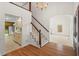 Open entryway with staircase, chandelier, hardwood flooring and an arched doorway at 6321 Malvern Ln, Hillsborough, NC 27278