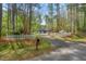 Charming home featuring a white picket fence, and a long driveway through a wooded lot at 6321 Malvern Ln, Hillsborough, NC 27278
