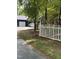 Exterior view of the home featuring a driveway and a white picket fence at 6321 Malvern Ln, Hillsborough, NC 27278