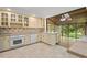 Well-lit kitchen featuring neutral countertops and cabinetry, open to the sunroom at 6321 Malvern Ln, Hillsborough, NC 27278