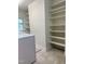 Laundry room with shelving, tile floors, and window for natural light at 6321 Malvern Ln, Hillsborough, NC 27278