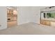 Bright living room showcasing open access to the kitchen and large windows at 6321 Malvern Ln, Hillsborough, NC 27278