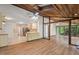 Open-concept living space combining the kitchen and sunroom under a wood ceiling at 6321 Malvern Ln, Hillsborough, NC 27278