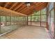 Spacious wooden porch featuring a high ceiling with fans and an enclosed screened-in area at 6321 Malvern Ln, Hillsborough, NC 27278