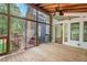 Enclosed wooden porch with ceiling fans and view of the backyard and access to the home interior at 6321 Malvern Ln, Hillsborough, NC 27278
