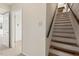 Stairway with wood treads and a dark wood handrail, leading to the upper level at 6321 Malvern Ln, Hillsborough, NC 27278