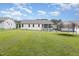 Spacious backyard with a screened in porch, patio, and trampoline at 65 Cattail Ln, Zebulon, NC 27597
