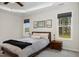 Bright bedroom featuring a ceiling fan, plush carpet, and windows with backyard views at 65 Cattail Ln, Zebulon, NC 27597