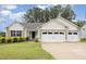 Inviting single-story home with a two-car garage and a neatly landscaped front yard at 65 Cattail Ln, Zebulon, NC 27597