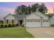 Charming single-story home featuring a two-car garage and a well-manicured front lawn at 65 Cattail Ln, Zebulon, NC 27597