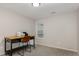Simple home office with a wood desk, rolling chair, and ample natural light at 65 Cattail Ln, Zebulon, NC 27597