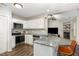 Modern kitchen boasts granite countertops, stainless steel appliances, and a view of the living area at 65 Cattail Ln, Zebulon, NC 27597