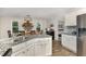 Open-concept kitchen featuring white cabinetry, granite countertops, and a view into the breakfast nook at 65 Cattail Ln, Zebulon, NC 27597