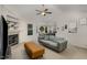 Cozy living room featuring a fireplace, neutral-toned sofa, and a glimpse into the dining area at 65 Cattail Ln, Zebulon, NC 27597