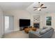 Bright living room with a corner fireplace, a comfortable sofa, and a large window offering natural light at 65 Cattail Ln, Zebulon, NC 27597