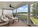 A screened-in porch with outdoor seating and a ceiling fan overlooking backyard at 65 Cattail Ln, Zebulon, NC 27597