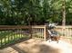 Outdoor deck featuring seating and a view of the wooded landscape at 6760 Keansburg Rd, Gibsonville, NC 27249