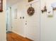 Inviting entryway with hardwood floors and a decorative wreath on the door, creating a warm first impression at 6760 Keansburg Rd, Gibsonville, NC 27249