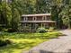 Charming two-story home with a welcoming front porch and a lush, landscaped yard surrounded by mature trees at 6760 Keansburg Rd, Gibsonville, NC 27249