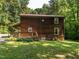 Side view of home with a covered porch and well-maintained lawn at 6760 Keansburg Rd, Gibsonville, NC 27249