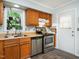 Functional kitchen with wood cabinets, stainless steel appliances, and a view from the window at 6760 Keansburg Rd, Gibsonville, NC 27249