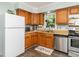 Functional kitchen with wood cabinets, stainless steel appliances, and a view from the window at 6760 Keansburg Rd, Gibsonville, NC 27249