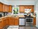 Functional kitchen with wood cabinets, stainless steel appliances, and decor at 6760 Keansburg Rd, Gibsonville, NC 27249