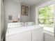 Functional laundry room with a washer, dryer, and a window with natural light at 6760 Keansburg Rd, Gibsonville, NC 27249