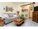 Relaxing living room with a neutral color palette, inviting sofa, and charming decor accents for a serene atmosphere at 6760 Keansburg Rd, Gibsonville, NC 27249