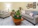 Comfortable living room featuring a plush sofa, patterned armchair, and well-placed plants for a cozy feel at 6760 Keansburg Rd, Gibsonville, NC 27249