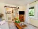 Bright living room with large windows, a comfortable sofa, and a stylish TV cabinet offering a cozy space at 6760 Keansburg Rd, Gibsonville, NC 27249