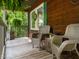 Relaxing porch with wicker chairs, perfect for enjoying the surrounding greenery and peaceful atmosphere at 6760 Keansburg Rd, Gibsonville, NC 27249