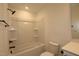 This bathroom includes a shower and tub combo, modern fixtures, and a neutral color palette at 6973 Doddridge Ln # 17, Cary, NC 27519