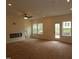 Spacious living room with modern fireplace and plenty of natural light from large windows and glass door at 6973 Doddridge Ln # 17, Cary, NC 27519